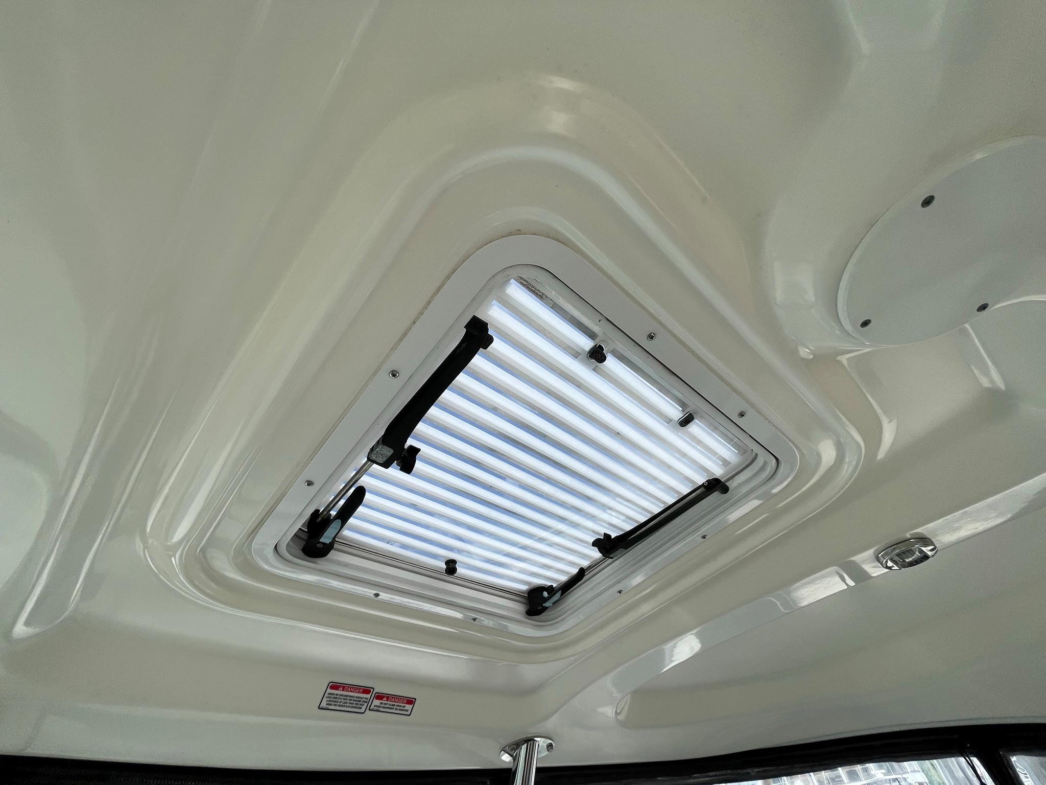 OPENING OVERHEAD HATCH IN THE HARD TOP ABOVE HELM DECK